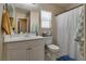 Well-lit bathroom with vanity, mirror, and shower with curtain at 7919 Mineral Peak St, Las Vegas, NV 89166