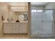Modern bathroom featuring double vanity, white shaker cabinets, and separate glass enclosed shower at 7919 Mineral Peak St, Las Vegas, NV 89166