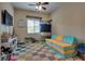 Bright and airy bedroom with neutral tones, large window, and ample space for seating at 7919 Mineral Peak St, Las Vegas, NV 89166