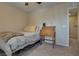Cozy bedroom with neutral tones, a comfortable bed, and a quaint wooden writing desk at 7919 Mineral Peak St, Las Vegas, NV 89166