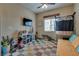 Bright and airy bedroom with neutral tones, large window, and ample space for play at 7919 Mineral Peak St, Las Vegas, NV 89166