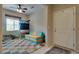 Inviting entryway featuring a colorful rug, modern seating and a ceiling fan for added comfort at 7919 Mineral Peak St, Las Vegas, NV 89166