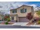 Charming two-story home featuring a neutral color palette, blue shutters and well-maintained landscaping at 7919 Mineral Peak St, Las Vegas, NV 89166