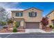 Two-story home featuring a two-car garage and manicured front yard with landscaping at 7919 Mineral Peak St, Las Vegas, NV 89166