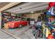 Organized garage with car, bikes and storage shelves for tools and household items at 7919 Mineral Peak St, Las Vegas, NV 89166