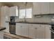 Bright kitchen area features stainless steel appliances, granite countertops, and ample cabinetry at 7919 Mineral Peak St, Las Vegas, NV 89166