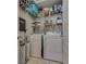 Functional laundry room featuring a washer, dryer and shelving for storage solutions at 7919 Mineral Peak St, Las Vegas, NV 89166