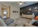 Inviting living room boasts modern decor, dark accent wall, media center, and neutral toned furnishings at 7919 Mineral Peak St, Las Vegas, NV 89166