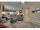 Comfortable living room featuring plush seating, ceiling fan, and view into bright kitchen at 7919 Mineral Peak St, Las Vegas, NV 89166