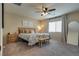 Inviting primary bedroom with large window, ceiling fan and soft carpeting at 7919 Mineral Peak St, Las Vegas, NV 89166