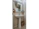 Stylish powder room featuring a modern pedestal sink, elegant mirror, and decorative accents at 7919 Mineral Peak St, Las Vegas, NV 89166