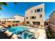 Backyard with a refreshing pool, spa, landscaping, and a two-story house in the background at 8179 Shale Canyon St, Las Vegas, NV 89139