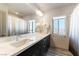 Bright bathroom with double sinks, marble countertop, and a shower/tub combo at 8179 Shale Canyon St, Las Vegas, NV 89139
