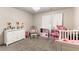A room with a crib, dresser, and play kitchen at 8179 Shale Canyon St, Las Vegas, NV 89139