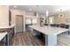 A kitchen features a large island with seating, stainless steel appliances, and wood-look floors at 8179 Shale Canyon St, Las Vegas, NV 89139