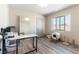 Bright office with a large mirror, white desk, wood-style floors and a pet area at 8179 Shale Canyon St, Las Vegas, NV 89139