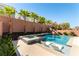 Beautiful backyard pool and spa area with landscaping, palm trees, and a serene atmosphere at 8179 Shale Canyon St, Las Vegas, NV 89139