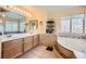 Bathroom suite with double sink vanity, large soaking tub, and neutral tile finishes at 8324 Brittany Harbor Dr, Las Vegas, NV 89128