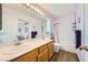 Bathroom featuring double sinks, white cabinets, large mirror, and shower with tub at 8324 Brittany Harbor Dr, Las Vegas, NV 89128
