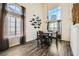 Dining room with dark wood table set with tall windows and high ceiling at 8324 Brittany Harbor Dr, Las Vegas, NV 89128