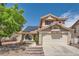 Two-story home with red tile roof, solar panels, two-car garage, brick steps and low maintenance landscaping at 8324 Brittany Harbor Dr, Las Vegas, NV 89128