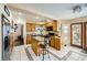 The kitchen features a kitchen island, hardwood cabinets, and a stainless steel refrigerator at 8324 Brittany Harbor Dr, Las Vegas, NV 89128