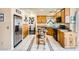 Spacious kitchen featuring oak cabinets, granite countertops, stainless steel fridge and decorative tiled flooring at 8324 Brittany Harbor Dr, Las Vegas, NV 89128