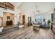 Bright living room featuring hardwood floors, large arched window, and elegant furnishings at 8324 Brittany Harbor Dr, Las Vegas, NV 89128