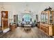 Cozy living room showcasing hardwood floors, unique decor, and a large arched window at 8324 Brittany Harbor Dr, Las Vegas, NV 89128