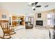 The kitchen is connected to the living room and the living room has a fireplace and ceiling fan at 8324 Brittany Harbor Dr, Las Vegas, NV 89128