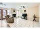 The living room has tile floor, fireplace, ceiling fan, and large television at 8324 Brittany Harbor Dr, Las Vegas, NV 89128
