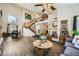 Open-concept living room featuring soaring ceilings, a staircase, and hardwood floors at 8324 Brittany Harbor Dr, Las Vegas, NV 89128