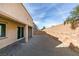 Wide shot of the gravel backyard featuring a covered patio and brick walls at 844 Aurelie Ridge St, Henderson, NV 89011