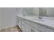 Bright bathroom featuring double sinks, white cabinets, and a large mirror at 844 Aurelie Ridge St, Henderson, NV 89011