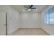A bright bedroom featuring neutral carpet, a ceiling fan, and a window with natural light at 844 Aurelie Ridge St, Henderson, NV 89011