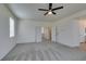 Large bonus room with neutral carpet, a ceiling fan, and doors leading to other rooms at 844 Aurelie Ridge St, Henderson, NV 89011