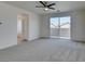 Bonus room featuring neutral carpet, a ceiling fan, and access to a patio area at 844 Aurelie Ridge St, Henderson, NV 89011