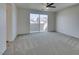 Bonus room with neutral carpet, fan, and sliding glass doors to a balcony or patio at 844 Aurelie Ridge St, Henderson, NV 89011