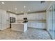 Modern kitchen with white cabinetry, stainless steel appliances, and an island at 844 Aurelie Ridge St, Henderson, NV 89011