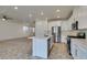 Bright kitchen features stainless appliances, a center island with sink, and tiled floors at 844 Aurelie Ridge St, Henderson, NV 89011