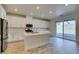 Modern kitchen features stainless appliances, a large island with sink, and plenty of natural light at 844 Aurelie Ridge St, Henderson, NV 89011