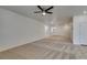 Open floor plan living area with neutral carpet, modern lighting, and stairway access at 844 Aurelie Ridge St, Henderson, NV 89011