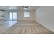 Spacious living room featuring neutral carpet, a ceiling fan, and natural light at 844 Aurelie Ridge St, Henderson, NV 89011