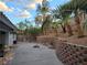 Landscaped backyard features mature palm trees and a retaining wall at 853 Rusty Anchor Way, Henderson, NV 89002