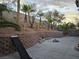 Spacious backyard featuring a retaining wall, landscaping, and seating area at 853 Rusty Anchor Way, Henderson, NV 89002