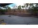 Backyard featuring tiered landscaping, a brick retaining wall, and a concrete patio at 853 Rusty Anchor Way, Henderson, NV 89002