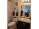 Cozy bathroom with toilet, sink, mirror and shower at 853 Rusty Anchor Way, Henderson, NV 89002