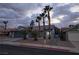 Charming single-story home featuring desert landscaping, mature palm trees, and a two-car garage at 853 Rusty Anchor Way, Henderson, NV 89002