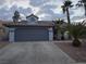 Single-story home showcases a two-car garage and desert landscaping at 853 Rusty Anchor Way, Henderson, NV 89002