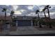 Single-story home with a two-car garage, mature palm trees, and a well-kept desert landscape at 853 Rusty Anchor Way, Henderson, NV 89002